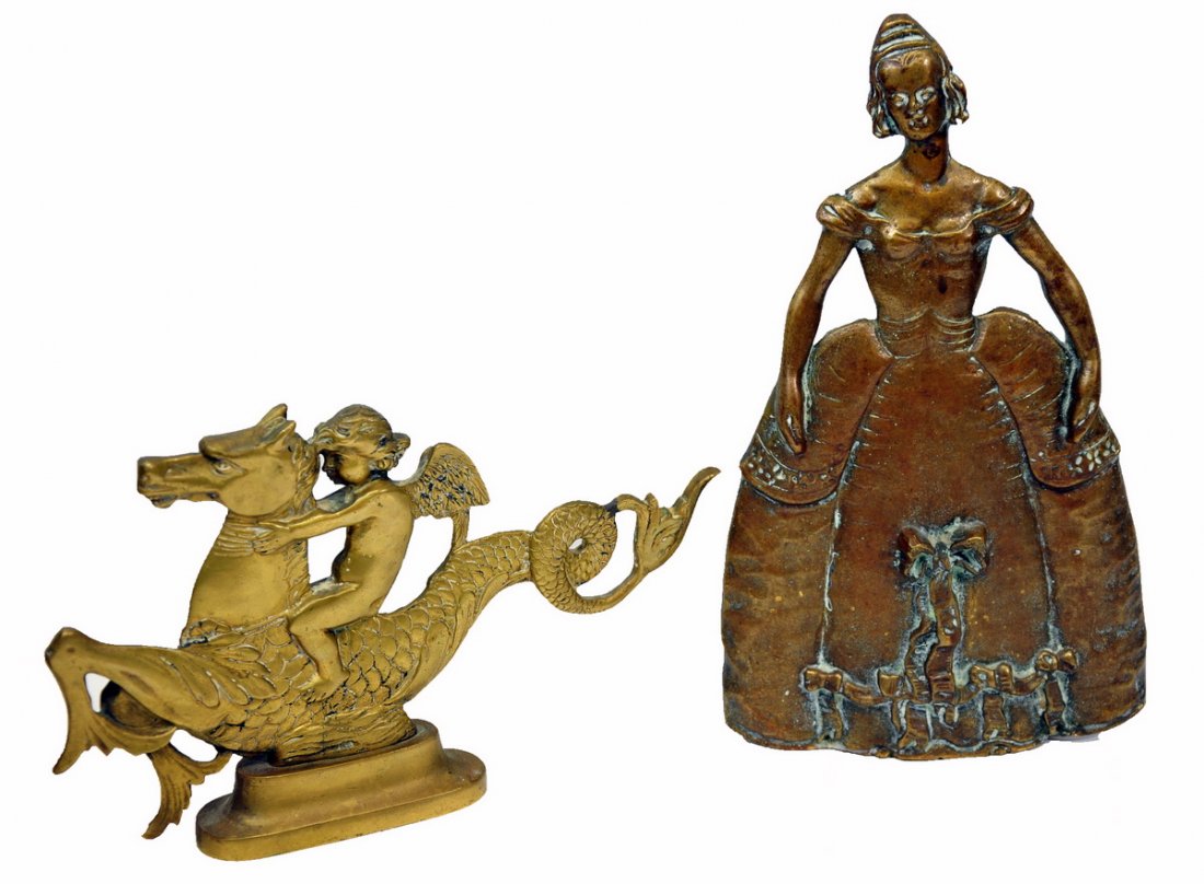 Two brass doorstops: lady 10 1/2" H and a Cherub riding on a mermaid horse 6 1/2"H x 9 1/2"L, and four French Tiebacks.