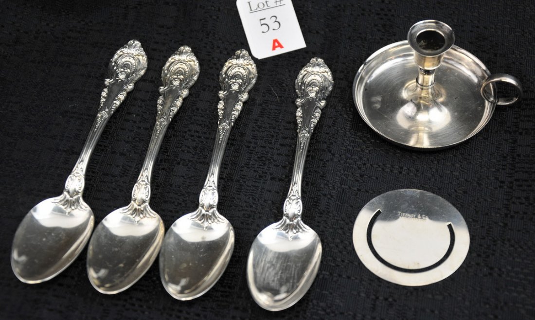 Lot of Tiffany and Wallace Sterling Silver: Lot includes a Tiffany 2" high sterling candle holder signed on the bottom; a sterling silver signed Tiffany circular bookmark, 2" in diameter; and 4 ornate sterling silver spoons, signed Wallace. Tot