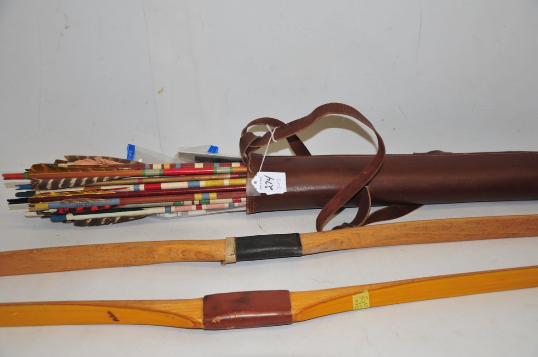 1950's Archery lot: One wood long bow, one wood and fiberglass bow with a leather quiver of vintage wood arrows.