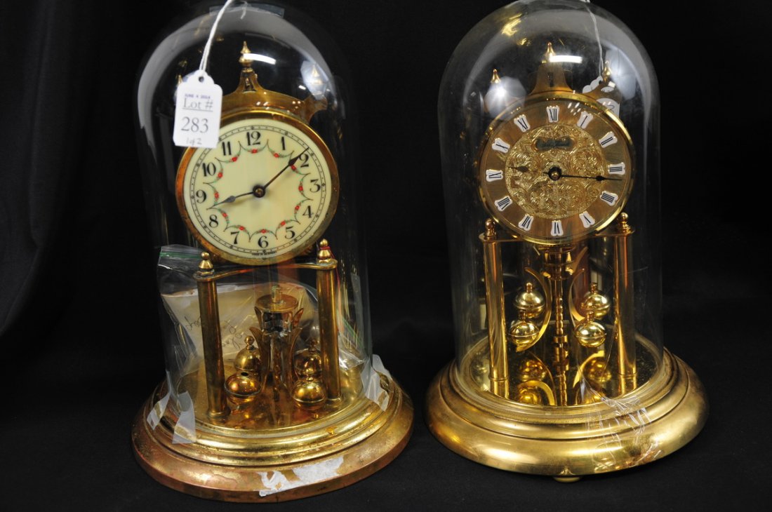 2 German Dome Clocks: One Seth Thomas dome clock measuring approx. 12" high with an 8" dia. base, made in West Germany; and one Original Kieninger & Obergfell 400 Day Clock, made in Germany, measuring approx. 12" high with