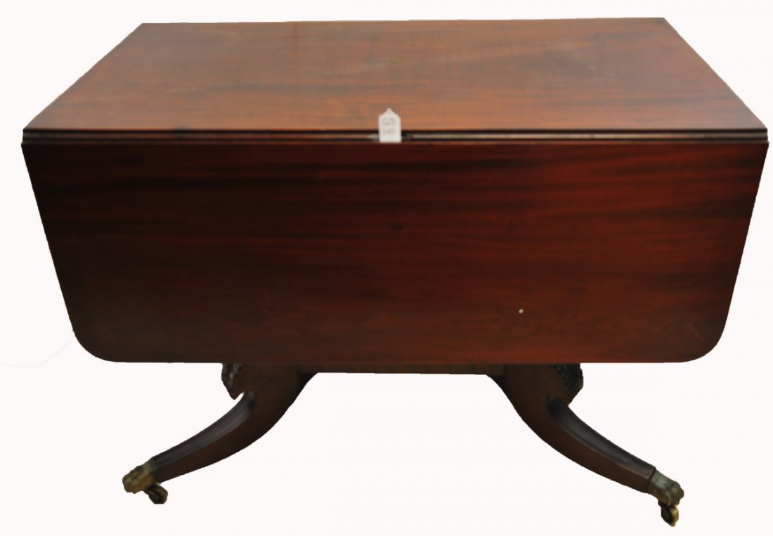 Mahogany Duncan Phyfe: drop leaf table, center base with four legs, brass claw feet on casters, has a drawer, 20" H x 40 1/2" L x 84" W with expanded leaves. Good antique table!