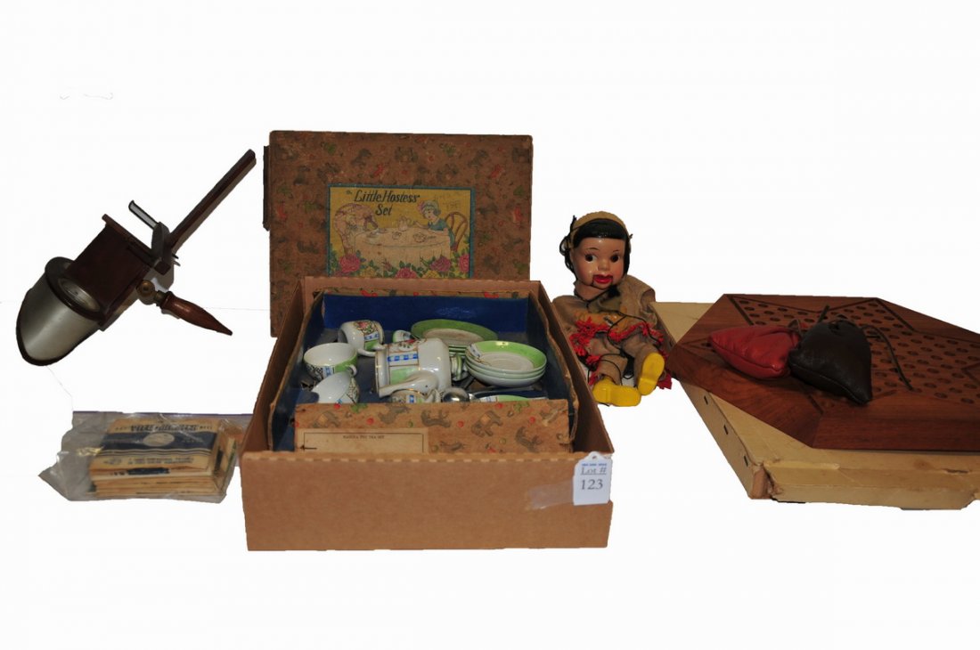 Collection of toys and games: Chinese checker game in original box #1063 produced in Denmark for Parker Bros. with marbles. A Marionette puppet of an American woman, stereoscope viewer with a view master films and a dolls tea set 
