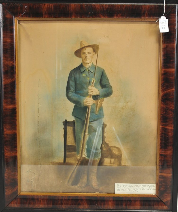 Colored photograph of Civil War soldier and weapon: has a tag that reads: Tinted portrait of Civil War soldier. Found in attic of Southgate House. May be picture of Horatio Southgate's son John B. who died on February 7, 1862 age 29. He would be a gran