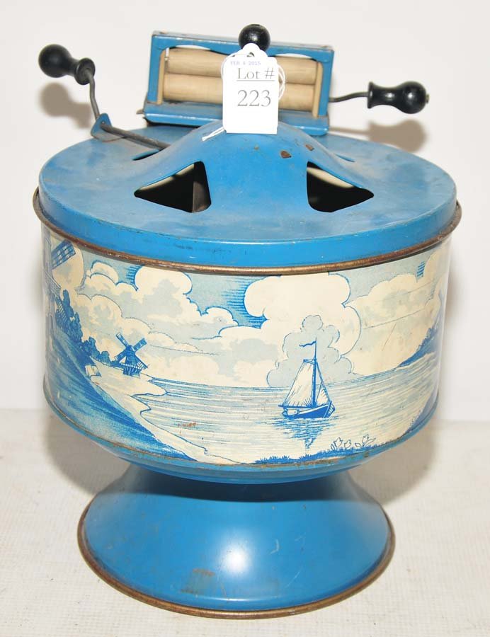 Toy wringer washing machine: made by Wolverine, USA, tin depicting windmill and Holland scene on side of toy. Condition is good, 11" H x 9 1/2" W, neat, old toy.