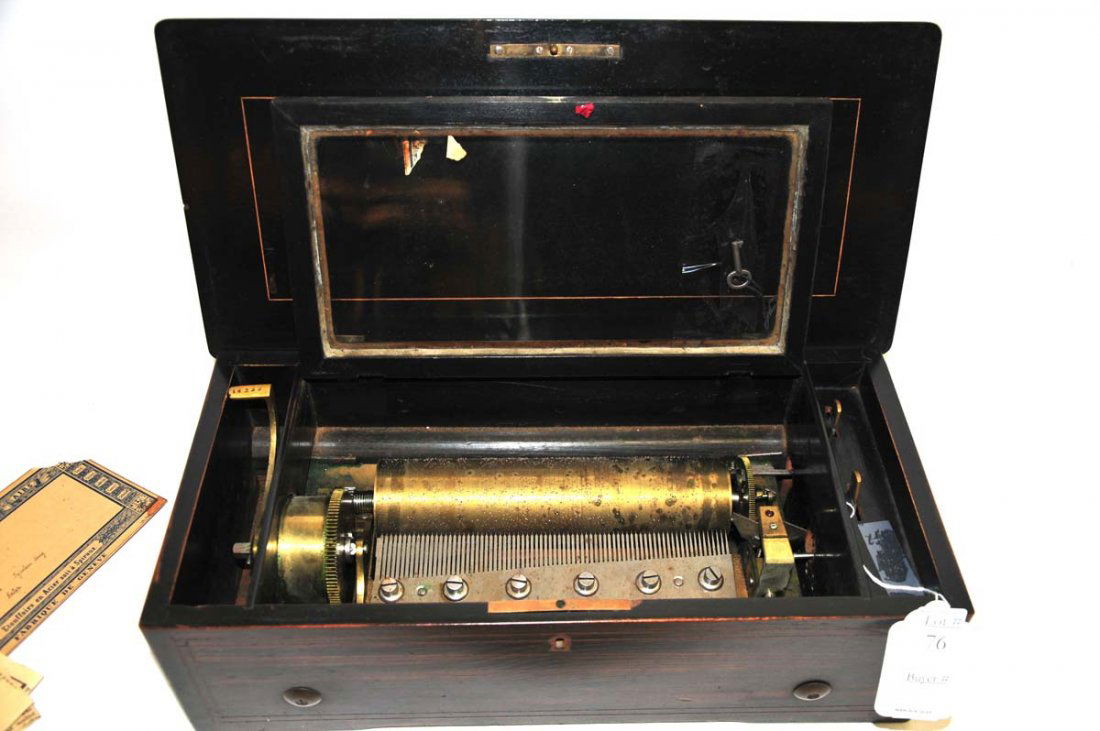 Six tune wooden music box: with key and card inside of songs played: My Lodging is on the Cold Ground, Die Wacht and Rhein, The Swiss Bride Les Ideales Waltz, L'Echo Des Ravines and Crispino. Working condition.