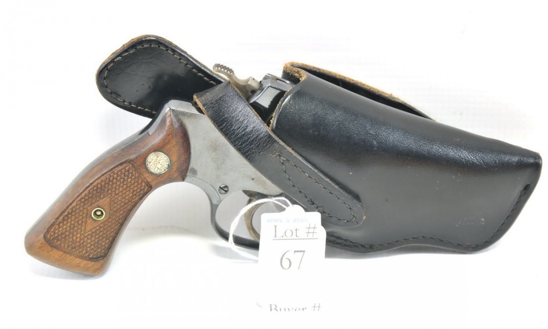 Smith and Wesson 38 Special: Revolver in leather holster.