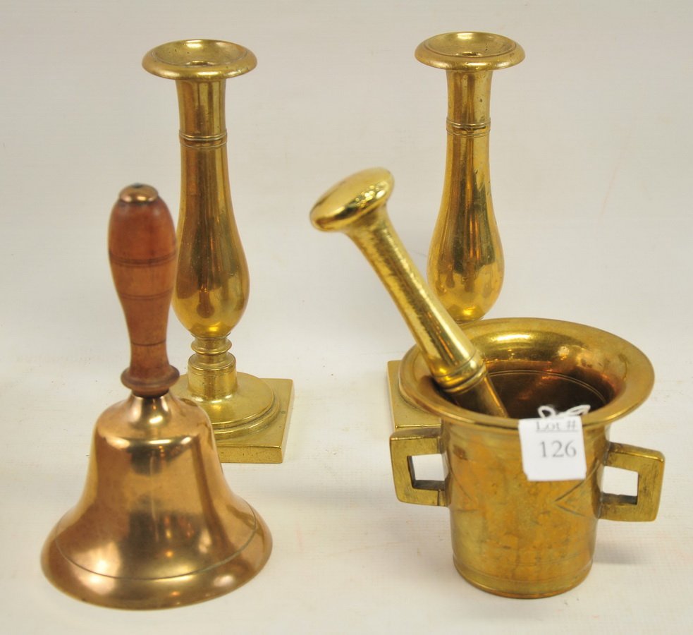 Misc collection: old brass school bell with wooden handle 8" H, a solid brass mortar 4 1/2" H with handles and pestle 8" H. Pair of quality old brass candlesticks 8 1/2" H.