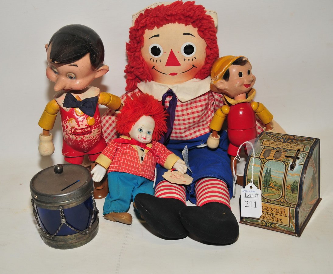 Toy Lot: to include Pinocchio doll signed on back of head 10 1/2", Pinocchio Doll by Ideal 8 1/2", 2 small tin banks, raggedy ann doll, L'll chips doll