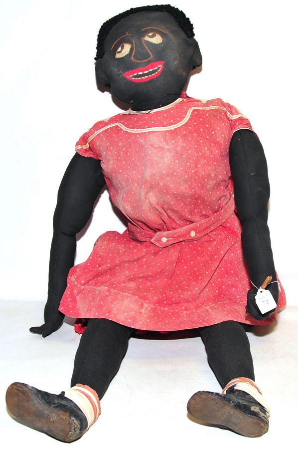 African American rag doll: with original shoes and dress. Outer dress is worn and faded, 4' L.