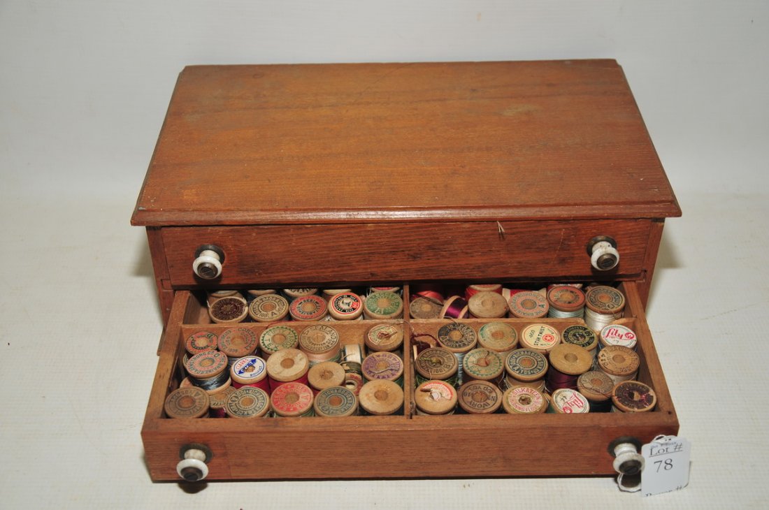 Estate fresh attic collection of old: thread spools in a two drawer wooden cabinet and vintage buttons.