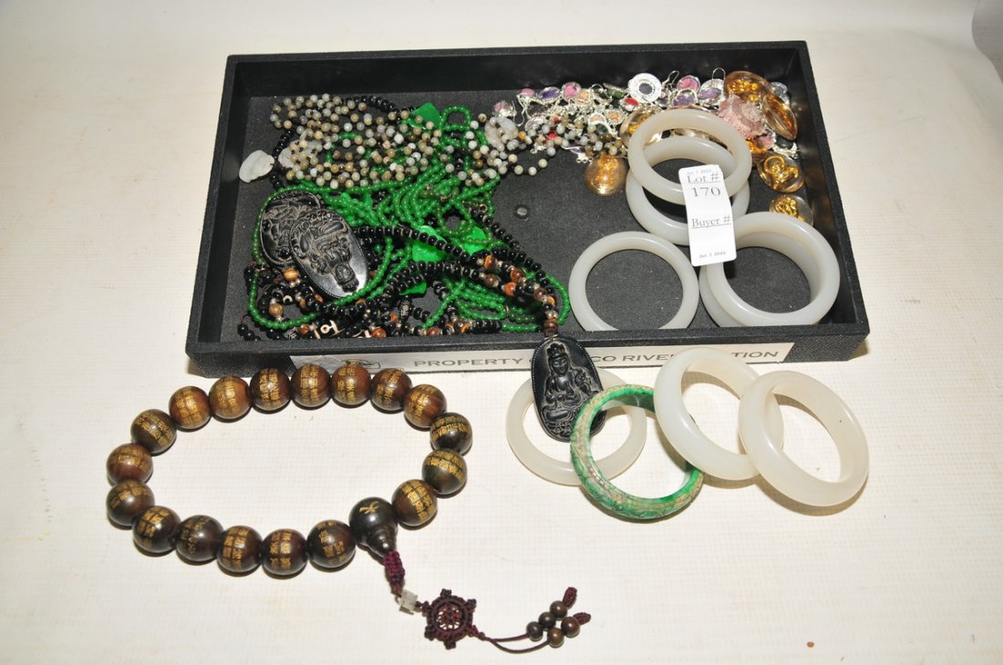 Collection of Asian jewelry items: to include eight white jade bracelets 1/2" H x 2 3/4" diameter, one green jade bracelet 1/2" H x 2 3/4" diameter, carved wood beaded necklace, three black jade necklaces, three white jade necklaces, 2