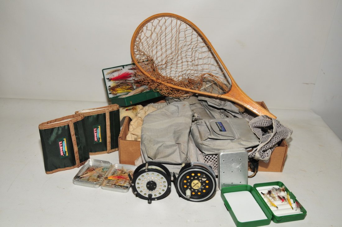 Collection of fly fishing items: Two fishing vests, pair of reels, misc. flies, small wooden net and more