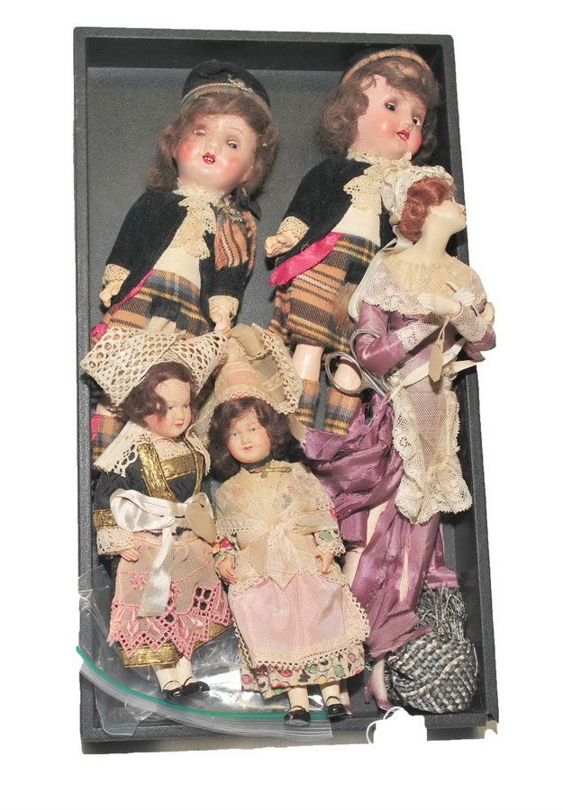 Collection of five vintage dolls: Pair of 9" vintage German dolls with open mouth and eyes in plaid skirts and boots. Marked Germany on back of neck. Pair of vintage dolls in Holland costume. 11" Victorian doll in purple dress and lac