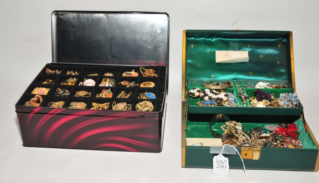 Two jewelry boxes filled with collection of: colorful costume jewelry of earrings, brooches, rings and necklaces.