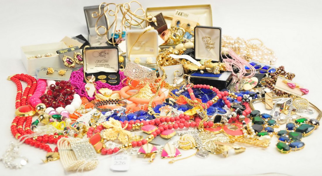 Large box of costume jewelry: colorful earrings, necklaces, bracelets Trifari and more.