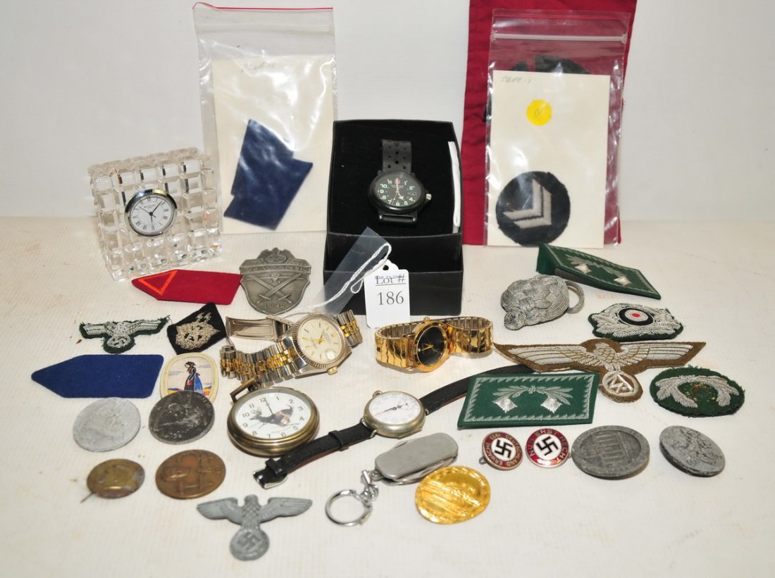 Collection of watches, pins, and patches: Nazi pins, Nazi patches, Swiss Army, Waterford and Rolex watch.
