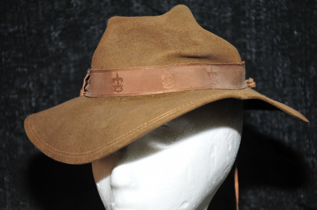 Collection of military items to include: khaki Garrison caps c. 1942, German ammo pouch, Julie Duff size 8 green kilt, white Jaypee holster, military hats with visors: US Coast Guard Auxilary Bancroft hat, Russian, US Navy and more.