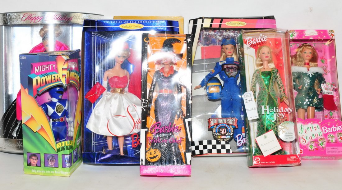 6 collectibles Barbies in Boxes: and one power ranger