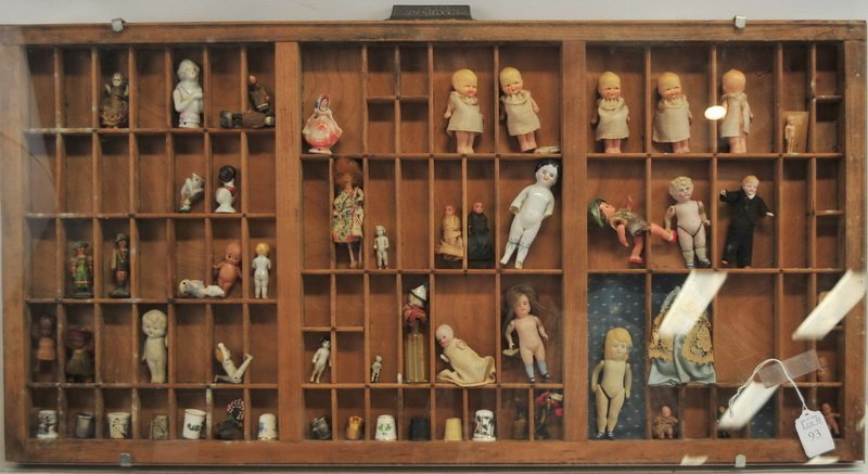 Framed Display of over 40 Antique Mini Dolls: Including, porcelain, celluloid, thimbles and more