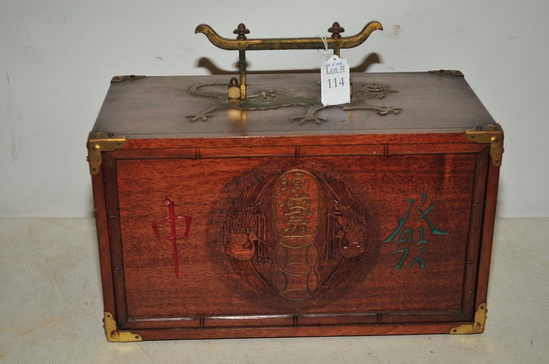 Antique Chinese Mahjong Game: Game is in very ornate Mahogany case and is brass adorned with dragon decoration, Carved front opens and game pieces are housed in 5 drawers. Original game booklet is enclosed and is dated 1923.