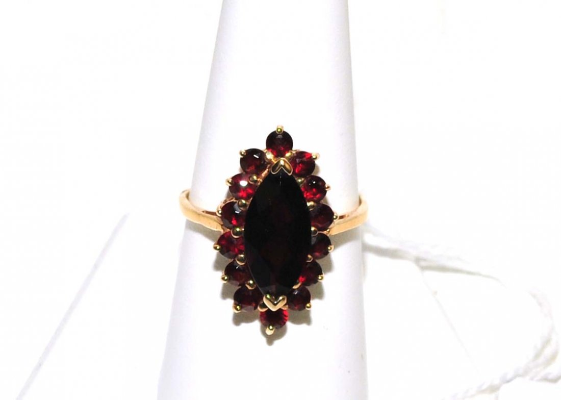 Ladies 10Kt. Garnet Ring 4 Grams: 10MM Marquis Center Stone surrounded by 13 round cut garnets, size 9