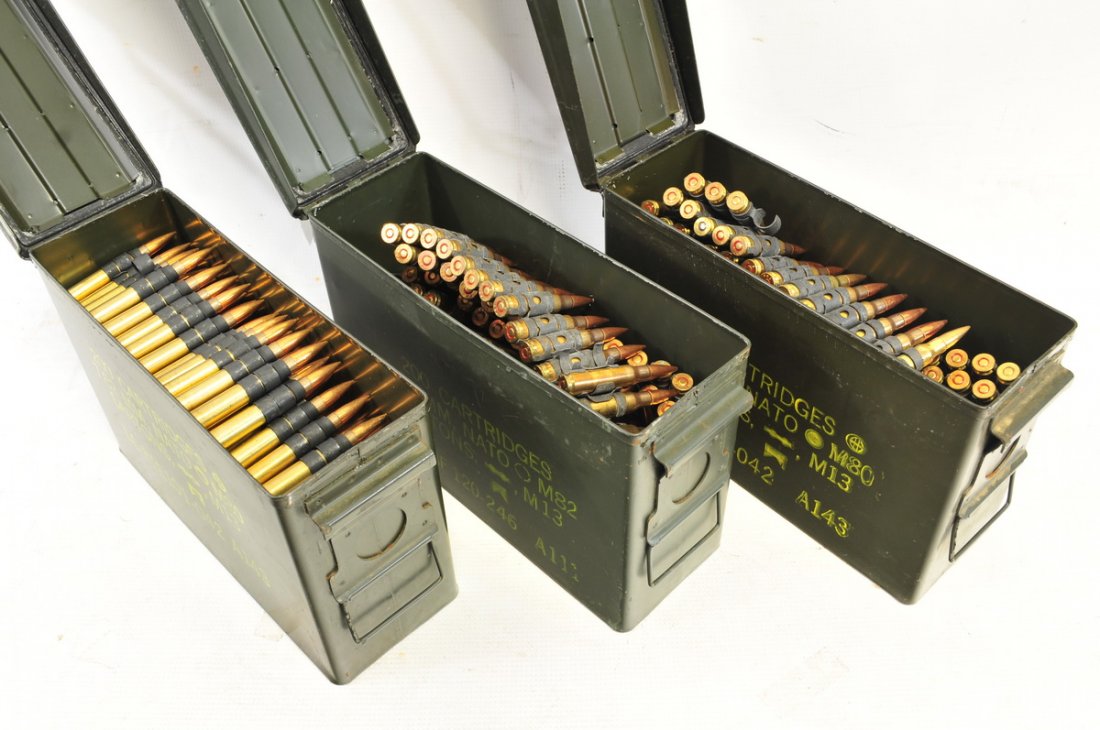 Three Vintage Machine Gun Ammo Belts: One 30-06 caliber/one 30 cal or 7.62 belts in 7.62 cans and one 7.62 Nato Ammo Belt in can