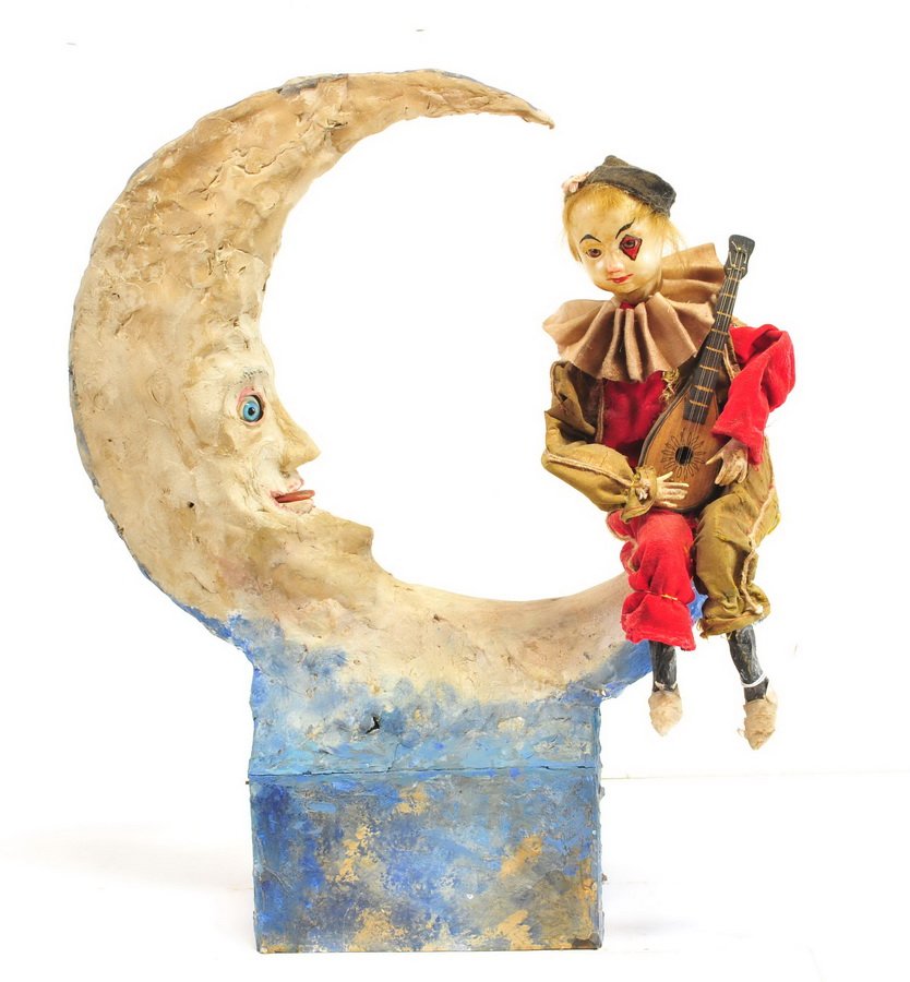 Vintage Pierrot Musical Automaton: Pierrot Serenading the Moon Musical Automaton with moving head, arm and leg. The moon's tongue moves and eyes with music. This is a wind up music box. This is a one of a kind you will never see anothe