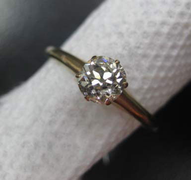10K Gold Diamond Engagement Ring: set with approximately 0.60 carat round solitaire, 1.20 dwts. (diamond not inspected out of setting)