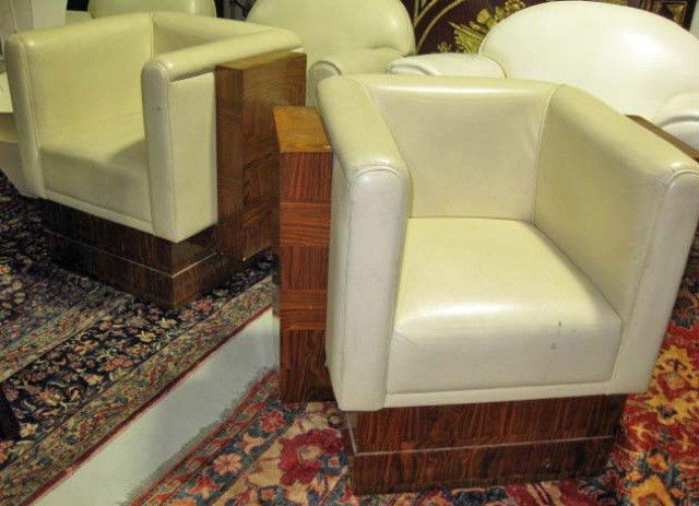 Pair of Art Deco Club Chairs: white leather and tiger maple veneer, some chips and stains to veneer, 29 x 34 x 25 inches