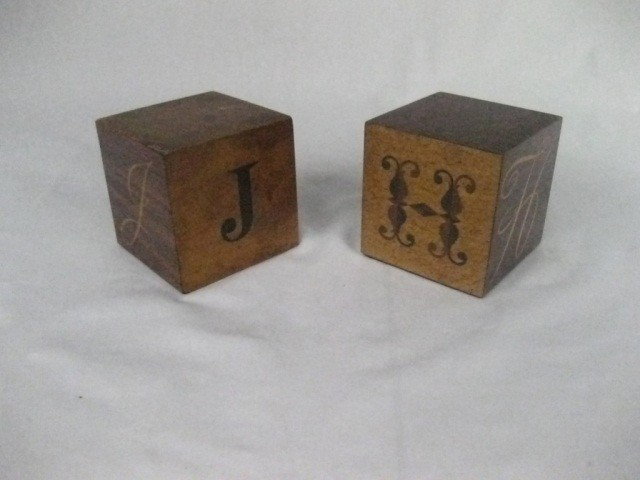 2 Szoeke Blocks: "J" and "H", "J" block having some veneer losses and warping. 4" cubes