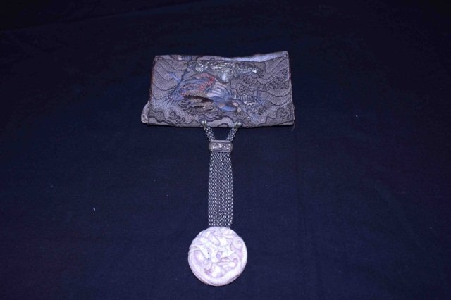 Japanese Early 20th Century Embroidered Bag: Silver mounts and chains and carved netsuke medallion