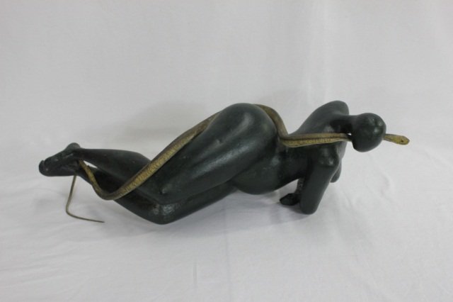 Model of Female Snake Charmer: Model of woman wrapped by snake Papier Mache Length 24 inches Height 9.5 inches Depth 8 inches