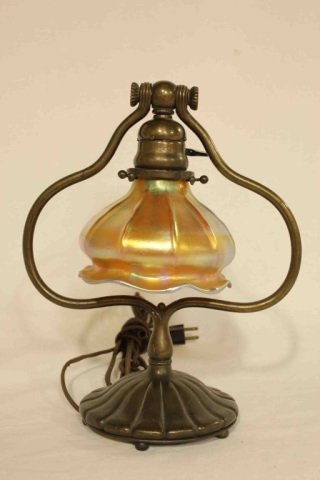 Tiffany Studios Desk Lamp: Bronze and Favrile Glass Height 12 inches. Louis Comfort Tiffany Tiffany Studios desk lamp with favrille glass shade. Bronze sculptural base and holder.