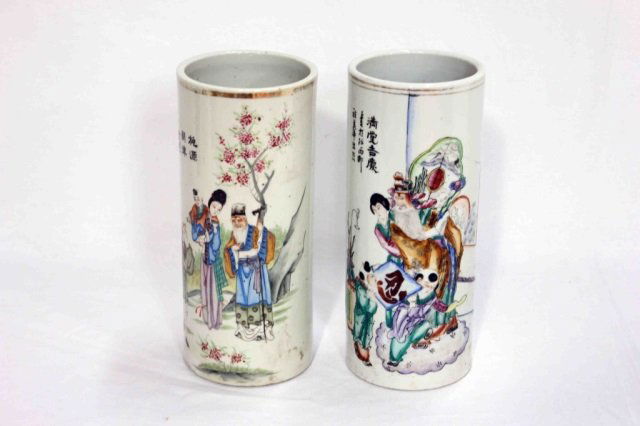 2 Chinese Porcelain Hat Stands: Height of smallest 11 inches. Groups of robed figures, woman holding baby, hand painted. Lines of characters on side and signed underneath of hat stand vases. Please see catalog for other lots of hat
