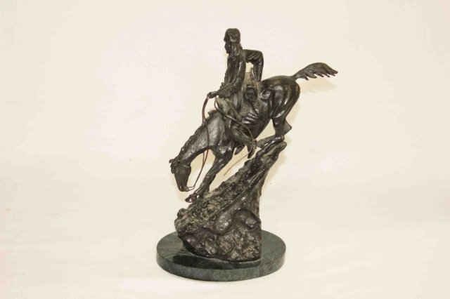 Reproduction Frederic Remmington: Bronze Sculpture Frontiersman Height 13 inches Diameter of base 6.5 inches. Reproduction of artist's work. Original artist's biography according to wikipedia, "Frederic Sackrider Remington (October 4,