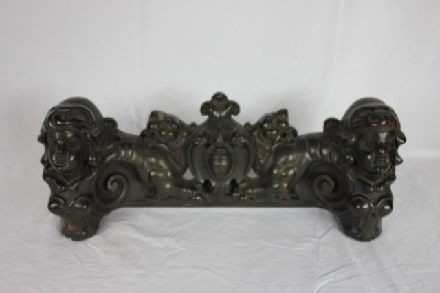 Pottery Sculpture with Two Heads and Shield: Possibly a fire place fender or an architectural element from a larger piece. Seems to be made from pottery. Well sculpted