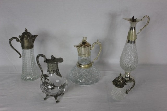 Five Silver Plate French Claret Pitcher Jugs: Tallest 14.5 inches in height. Five silver plated French cut glass / crystal Claret jugs in assorted styles; Art Nouveau, Victorian, Edwardian manners, etc.