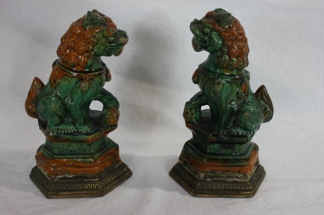 Pair of Asian Ceramic Foo Dogs: 8 inches tall. Mounted on gilt metal bases.