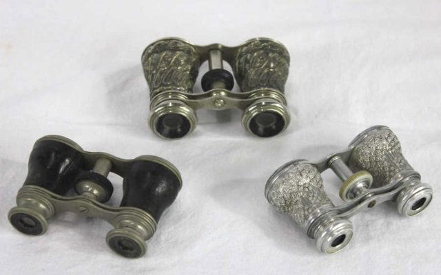 Three Antique / Vintage Opera Glasses, Lemaire Fab: One signed Lemaire Fab Paris. One with mother of pearl. Largest 4 inches wide and 3 inches in height.