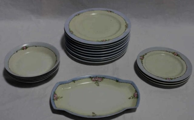 Hand Painted Art Nouveau Partial Dinner Service: 9 dinner plates, 1 serving tray, 4 bowls, 3 plates. All with hand painted floral border. Plates are 10 inches in diameter.