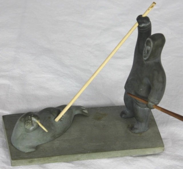 Carved Eskimo Inuit Statue w/ Carved Bone Details: Base measures 7 by 3 inches.