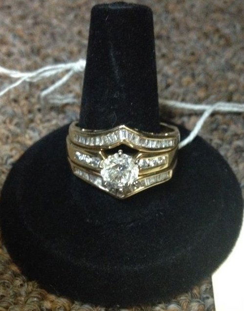 14K Yellow Gold Diamond Engagement Wedding Ring: 7.9 grams total weight. The engagement ring prong set with one brilliant cut round diamond approximately 1 carat in size with six diamond channel set on the shank. The fitted wedding ring has diamond