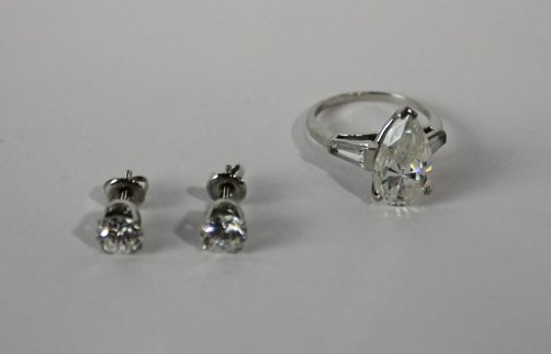 Platinum & 14K White Gold Mountings: 7.8 grams total weight. Comprising a platinum ring with paste stones and a pair of 14K white gold stud earring with screw backs paste stones.