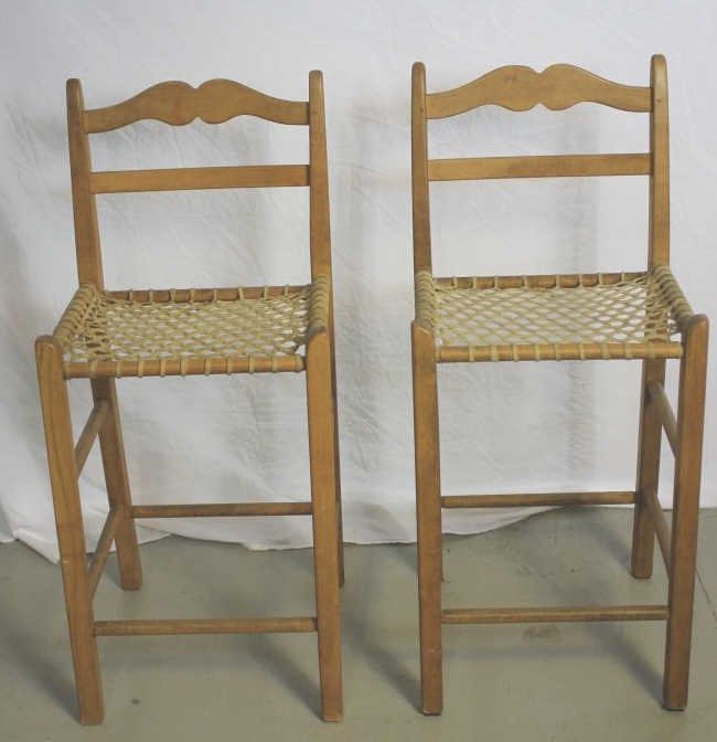 Pair of Rustic Style Counter Stools: Having slat backs and hide caned seats Height 37 Inches. Property of an Upper East Side Duplex.