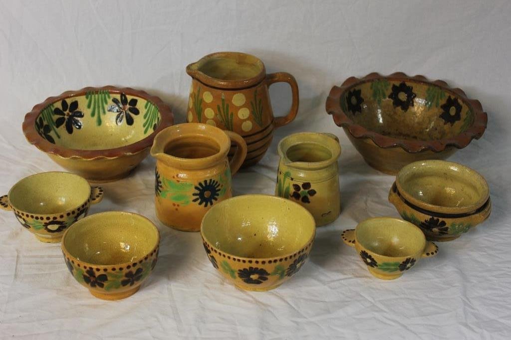 10 Pieces French Provencal Jaspe Pottery: Flower on cream colored ground. Comprising 2 large open bowls. Largest measures 10 inches diameter. 5 smaller bowls 2 cream pitchers. Minor chips.