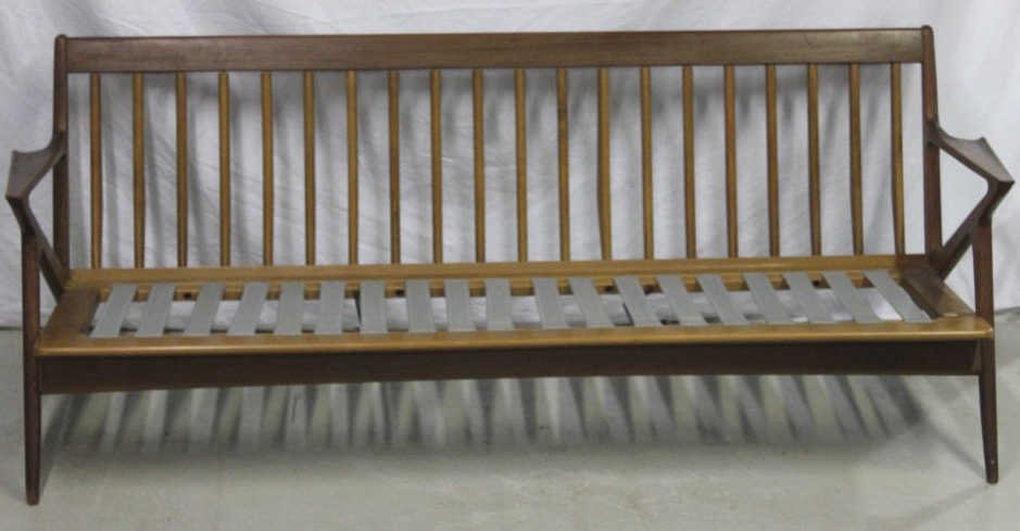 Mid Century Danish Modern Teakwood Sofa: Possibly made by Evans. Spindle backs solid wood construction Fagas rubber strapping seat support.