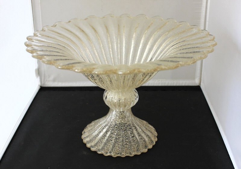 Large Modern Murano Art Glass Footed Compote: Flutted clear with gold flecking. Height 8 inches. Diameter 13 inches. Property of a South Salem NY Estate.