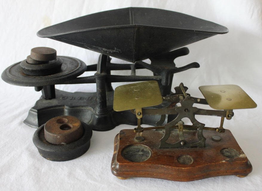 Group of 2 Antique Table Top Scales: Larger of the two. Not all weight present. Height 7 inches. Width 16 inches. Depth 8 inches . Property of a Bedford NY Home.