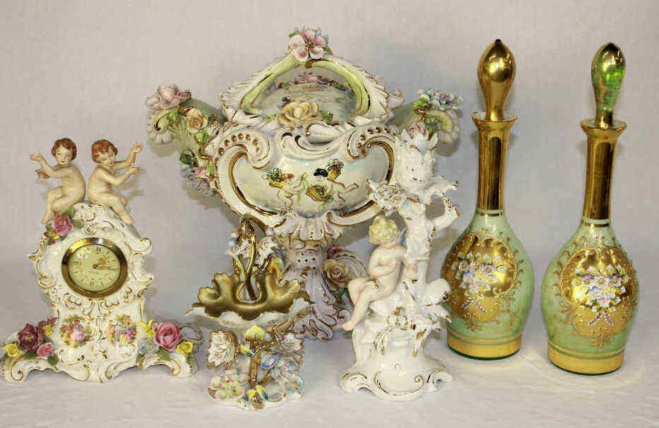 Capodimonte Porcelain Centerpiece: with three other porcelain items: one clock with Mercedes clock movement, vase and decorative figurine. Two painted glass decanters. Height approximately 14.5 Inches Width 14 Inches Depth 11 Inches