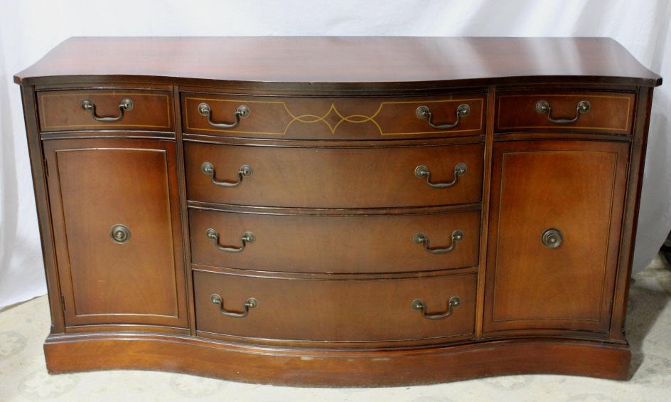 Georgian Style Inlaid Server by Bassett: With serpentine front. Two side drawers, two side doors, and four central drawers. Height 33.5 Inches Width 62.5 Inches Depth 20 Inches